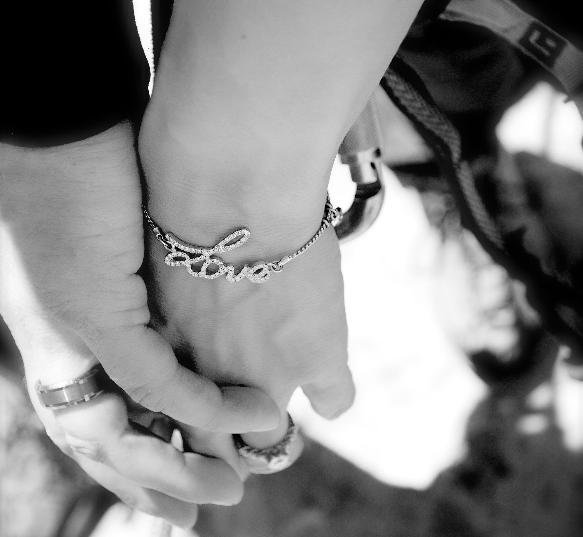 black and white photo of holding hands